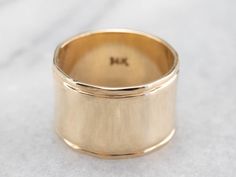 This vintage yellow gold band is absolutely stunning! Also called a cigar band, this ring has a high polish and beautiful shine. The yellow gold has a rich warmth to it that makes the ring all the more eye-catching. Metal: 14K Yellow Gold Width of Band: 12.1 mm Height off Finger: 1.0 mm Ring Size: 6.25 Marks: "14K" Stamped on the inside band Womens Wide Gold Wedding Band, Wide Gold Wedding Band Woman, Thick Gold Band, Thick Gold Ring, Wide Gold Ring, Wide Silver Band, Jewelry Knowledge, Fancy Rings, Body Adornment