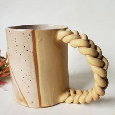 a ceramic mug with a twisted handle on it