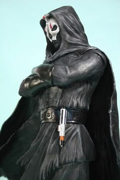 a darth vader action figure is shown with his arms crossed and head tilted