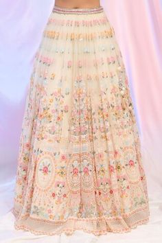 Cream lehenga featuring hand embroidered floral sequin work with a triangular cutwork hem. Accompanied by a padded blouse with cold shoulders and a sheer back, along with a matching dupatta adorned with sequins., Fit: Relaxed Sequins Embroidery Lehenga, Anarkali Lehenga With Multicolor Embroidery And Sequins, Fitted Evening Lehenga With Floral Embroidery, Evening Fitted Lehenga With Floral Embroidery, Elegant Semi-stitched Sequined Lehenga, Festive Floral Embroidered Skirt, Semi-stitched Cream Lehenga With Cutdana, Floral Lehenga, Sequins Embroidery