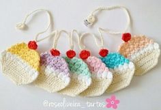 four crocheted hearts are hanging on a string