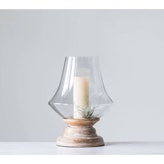 a candle is sitting in a glass vase