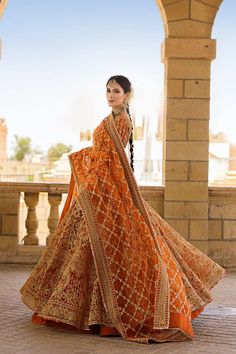 Captivating in Orange Lehenga Choli and Dupatta for Pakistani Bridal Elegance Gold Embroidered Dola Silk Gown, Traditional Gold Gown With Pallu, Traditional Gown With Gold Embroidery, Festive Gown With Gold Embroidery For Traditional Ceremonies, Gold Traditional Gown With Sheer Dupatta, Gold Gown With Dupatta For Traditional Ceremonies, Traditional Ceremonies Gold Gown With Dupatta, Gold Sheer Brocade Dupatta, Traditional Brocade Lehenga With Sheer Dupatta