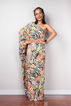 Off the shoulder boho chic maxi dress with floral print a one shoulder long sleeve dress for women with animal and flower print PRODUCT SIZE : Free Size * Chest : 40" will stretch to 44" * Waist : 40" will stretch to 44" * Hips : 40" will stretch to 44" * Sleeve length : 23" * Length : 56" - 57" from shoulder to hem (measured when laying flat) MATERIAL : * Premium ITY polyester > soft and comfortable to wear NOTE : * Model chest : 32", waist : 24" hips : 35" * Combined Height is 5"6 > I'm 160 cm (5"2) and I'm wearing 4" heels in the pictures * Accessories excluded POLICY : https://www.etsy.com/shop/Nuichan/policy CARE INSTRUCTIONS : * Wash separate in Cold water * Hand wash recommended * Hang to dry  IMPORTANT NOTE  *Please note that colours shown on your monitor may vary from the actual c Party Maxi Dress With Floral Print And Asymmetrical Neckline, One-shoulder Floral Maxi Dress For Party, Party One-shoulder Maxi Dress With Floral Print, Fitted Floral Print One Shoulder Dress, Fitted Maxi Dress With Asymmetrical Neckline For Vacation, Flowy One Shoulder Dress For Spring Party, Chic Asymmetrical Neckline Summer Maxi Dress, Elegant One Shoulder Printed Dress, Elegant One-shoulder Printed Dress