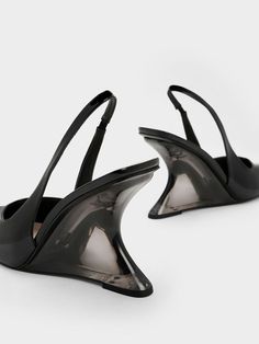 A modern twist on a classic, these slingback pumps come with stunning sculptural heels that will turn heads wherever you go. To top it off, these wedge heels have an eye-catching see-through design. The pointed-toed silhouette keeps these shoes looking sleek and polished, while the black patent finish exude a glossy shine. Wear them with a classy shirt dress for an effortlessly chic desk-to-dinner look. Classy Shirt Dress, Dress Down Day, Faux Leather Heels, Size Chart For Kids, Charles Keith, Black Wedges, Carbon Footprint, Slingback Pump, Sustainable Materials