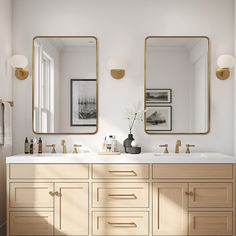 a bathroom with two sinks and mirrors on the wall