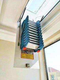 a window sill hanging from the side of a wall with a skylight above it