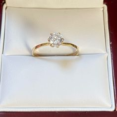 an engagement ring in a box on a table