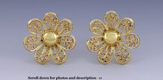 Presented is a sweet pair of 18 karat deep yellow gold flower form earrings. The earrings have posts for pierced ears and screw on backs for added security. These earrings are Middle or far Eastern and were made in the past 50 years. The decorative front of each earring is done in a pretty filigree wire flower form. Each screw back is marked 18K. Each earring is completely solid 18 karat gold purity, tested and guaranteed. This pair is in fabulous overall condition. There are no damages and no r Gold Clip-on Earrings In Flower Shape, Gold Clip-on Flower-shaped Earrings, Pierced Flower-shaped Earrings For Formal Occasions, Yellow Gold Flower-shaped Clip-on Earrings For Formal Events, Pierced Flower Shaped Earrings For Formal Occasions, Formal Flower Shaped Pierced Earrings, Formal Flower-shaped Pierced Earrings, Formal Yellow Gold Flower Earrings, Formal Yellow Flower-shaped Earrings