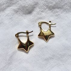 These star-shaped hoop earrings are made from silver/gold plated stainless steel and are safe for exposure to sweat and water without the threat of tarnishing.Length: ~0.75"Width: ~0.6" Star Hoop Earrings, Dope Jewelry, Funky Jewelry, Jewelry Lookbook, Star Design, Gold Star, Dream Jewelry, Pretty Jewellery, New Jewelry