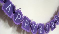 purple happy birthday banner hanging on the wall