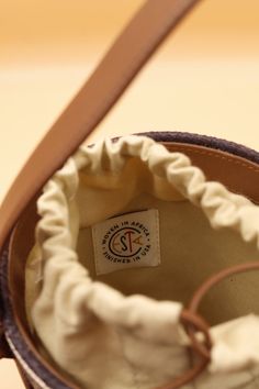 A perfect summer bucket handbag by Cesta Collective. This little pail has it all! A brown leather hand strap, a tan linen bag lining with a leather drawstring closure. Cute and petite this raffia lunch pail purse is precious and for a great cause! Each Cesta is handwoven in Rwanda, finished in Italy or USA. Luxury basket bags with a purpose. We are fans! Product Measurement Details: Height w/o straps: 6.5" Circumference: 18.5" Depth: 4.5" Damage to consider: See images in carousel of any damage. Luxury Lunch Bags, Bag Lining, Lunch Pail, Basket Bags, Bucket Handbags, Hand Strap, Basket Bag, Linen Bag, Summer Bucket