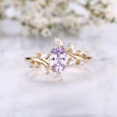 a ring with an amethorate surrounded by white flowers