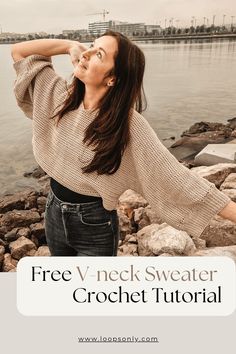 a woman standing on rocks next to the water with her hands behind her head and text overlay that reads free v - neck sweater crochet