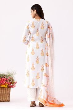 Ivory A-Line kurta with all over yellow floral block print, crochet lace work details and V neck. Paired with pant with polka dot print and mulmul dupatta with crochet lace border.
Components: 3
Pattern: Printed and Embellished
Type Of Work: Floral, Polka Dot Block Print and Crochet Lace Work
Neckline: V Neck
Sleeve Type: Three Quarter Sleeves
Fabric: Cotton Cambric, Dupatta: Mulmul
Color: Ivory
Other Details: 
Cut work hem
Front gathered details
Printed dupatta
Side slits
Occasion: Puja,Work - Crochet Lace Border, Floral Block Print, Kurta Set For Women, Printed Dupatta, A Line Kurta, Lace Border, Kurta Set, Cut Work, Polka Dot Print