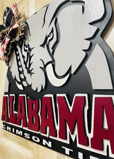 a sign that is on the side of a door saying,'alabama crimson tide '