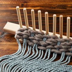 a close up of a weaving machine on a wooden table