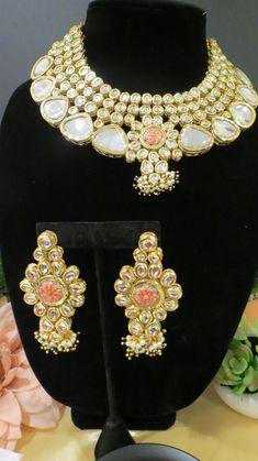 This beautiful choker is a modern twist to traditional jewelry and comes in a gold finish to match any outfit as desired. The choker is made of high quality stones and is a statement piece that can be dressed accordingly. The set comes with matching earrings and Tikka for a complete look. Designer Gold Jeweled Jewelry, Designer Jeweled Gold Jewelry, Elegant Kundan Choker Necklace, Elegant Kundan Choker Necklace For Festivals, Designer Gold Kundan Necklace, Elegant Kundan Jeweled Choker, Designer Gold Necklaces For Festivals, Designer Gold Kundan Necklace For Gift, Heavy Designer Kundan Necklace For Festive Occasions