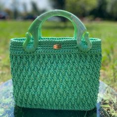 A green jewel that shines your style.With its ideal size,  "Esmeralda" provides ample space for your essentials, making it a safe choice for women seeking both style and functionality! Esmeralda is a crochet bag in green, featuring textured filaments that add a unique touch to its artisanal beauty.  Its resin handles are particularly distinctive, while the inner lining boasts a green patterned fabric that adds a lively flair. T he rigid green faux leather bottom provides structure to the bag. Me Green Beach Bag With Detachable Handle, Green Shoulder Bag With Detachable Handle For Beach, Green Square Crochet Bag As Gift, Green Crochet Bag For Gift, Green Square Crochet Bag For Gift, Green Handheld Crochet Bag For Beach, Handmade Green Shoulder Bag For Beach, Handmade Green Crochet Bag For Summer, Green Handheld Crochet Bag For Summer