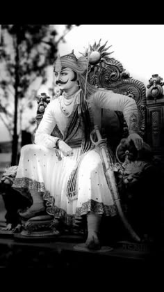 an old photo of a woman sitting on a chair with a cat nearby in black and white