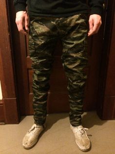 These are authentic BDU tiger camouflage pants that I tailor for a more stylish fit. Since these are authentic BDU pants, the sizes are unconventional in that they have adjustable waist tabs. The pictured model typically wears a size 30 x 32. He is wearing a size Small Regular with the leg opening tapered to 7 inches flat. If you have any questions or would like a more personalized fit, please message before ordering! - - - - - - - - - - - - - - - - - - - - - - - - - - - - - - - - - - - - - - - Camouflage Cargo Pants With Tapered Leg, Camouflage Tapered Leg Pants With Cargo Pockets, Fitted Combat Bottoms With Cargo Pockets, Fitted Camouflage Bottoms With Cargo Pockets, Camouflage Tapered Leg Cargo Pants, Camouflage Tapered Leg Pants With Pockets, Fitted Camouflage Pants With Cargo Pockets, Military Camouflage Jeans With Cargo Pockets, Stretch Military Camouflage Bottoms