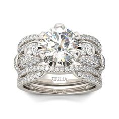 a white gold ring set with an oval cut diamond surrounded by two rows of diamonds