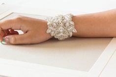 Crystal Wedding Bracelet for Bride, Beaded cuff for the bride, Silver and white bridal bracelet , Style- BA02Finished with ivory tulle fabricThe length of the tulle fabric is more than what you would normally need. This would allow you to tie the tulle to your linking and cut out the additional tulle fabric.Length = 5 to 5.5Width = 2.2 to 2.5 inchesOver all color = Silver and white beadsThese are approximate measurementsShipping :-  Please allow 4 to 6 weeks to complete workShop Policy : All ite Wedding Beaded Bangle Jewelry, Beaded Bangle Wedding Jewelry, Beaded Bangle Jewelry For Wedding, Elegant Wedding Bangle Cuff Bracelet, Silver Beaded Bracelets For Wedding, Elegant White Crystal Bracelet For Weddings, White Hand Set Bridal Accessories For Wedding, Wedding Beaded Bangle Pearl Bracelet, Elegant Beaded Cuff Bracelet For Wedding