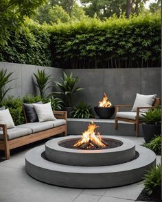 an outdoor fire pit surrounded by furniture and plants