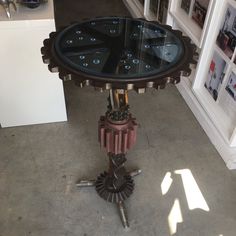 a table with a clock on it sitting in the middle of a room