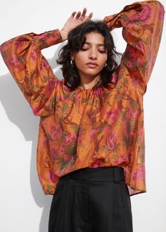 Long-sleeve blouse with a sheer finish. Featuring voluminous sleeves with fitted, buttoned cuffs.• Keyhole closure at the neck• Round neckline• Raglan sleeves• Length of blouse:60cm / 23.6" (Size S) Silk Tops With Blouson Sleeves For Daywear, Silk Blouse With Blouson Sleeves, Fall Silk Top With Gathered Sleeves, Spring Long Sleeve Top With Balloon Sleeves, Sheer Sleeves Long Sleeve Top For Fall, Silk Top With Gathered Sleeves For Fall, Billowy Tops With Gathered Sleeves For Work, Chic Billowy Padded Blouse, Feminine Gathered Sleeves Top For Fall