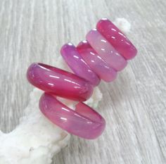 Gorgeous selection of Natural agate carved stone band rings in shades of pale pink and fucshia - available in multiple sizes from 4.5 to 9. Colorful gemstone band rings in boho style, good as stacking rings or to mix and match. Colors and sizes are shown in the photos. Please see all pictures and read. Then select your variation at checkout. Ring sizes and convertion: 4.5, 5, 6 1/4, 6.5, 6 3/4, 7, 7 1/4, 7.5, 9 ( US and Canada ) I 1/2, J 1/2, M 1/2, N, N 1/2, O, O 1/2, P, R 3/4 ( UK and Australi Handmade Bohemian Pink Ring, Pink Bohemian Rings For Jewelry Making, Handmade Adjustable Pink Crystal Ring, Bohemian Pink Gemstone Rings, Pink Natural Stones Ring Jewelry, Pink Rings With Natural Stones For Gift, Unique Pink Crystal Round Ring, Unique Pink Round Crystal Ring, Adjustable Pink Gemstone Stackable Rings