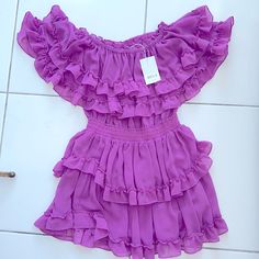 Never Worn, Tags Still On - Adorable Yet Sexy Magenta Dress. Detailed With Layered Ruffles And A Band Around The Waist To Enhance Your Curves. Lavender Ruffled Dress For Party, Lavender Ruffled Party Dress, Lavender Party Dress With Ruffles, Fitted Purple Dresses With Ruffles, Fitted Mauve Mini Dress With Ruffles, Chic Purple Mini Length Dresses, Chic Purple Mini Dresses, Elegant Lavender Mini Dress With Ruffles, Fitted Purple Dress With Ruffled Skirt