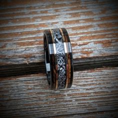 the wedding band is made from wood and silver