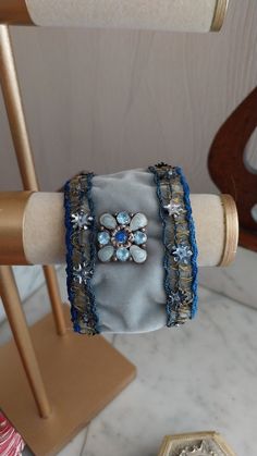 Handmade adjustable cuff created with old materials: Art Nouveau braid with gold thread and cabochon from the beginning of the 20th century, fully lined with blue satin. It is adjustable from 20.5 cm to 23 cm. The braid has been cleaned and restored. Its age gives it a unique patina and gives this cuff a charm that will only seduce you! Vintage Handmade Cuff Bracelet For Formal Occasions, Handmade Vintage Cuff Bracelet For Formal Events, Handmade Vintage Cuff Bracelet For Formal Occasions, Formal Vintage Handmade Cuff Bracelet, Handmade Adjustable Bracelet For Formal Occasions, Handmade Cuff Bracelet For Formal Occasions, Victorian Adjustable Cuff Bracelet For Gift, Victorian Style Adjustable Cuff Bracelet Gift, Handmade Adjustable Cuff Bracelet For Party