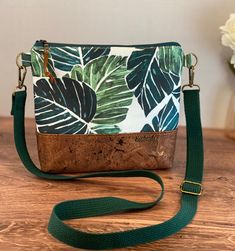 a green and white handbag sitting on top of a wooden table