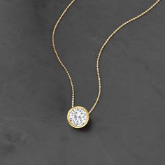 Ross-Simons - 1.20ct Bezel-Set Diamond Solitaire Necklace in 14kt Yellow Gold. 16". Utterly classic, this diamond necklace is a wardrobe essential. A marvelous 1.20 carat bezel-set round brilliant-cut diamond glows from polished 14kt yellow gold on a sleek box chain. Will add timeless diamond shimmer to your elegant everyday ensembles. Springring clasp, diamond necklace. Diamond birthstones are the perfect gift for April birthdays. Luxury Timeless Solitaire Diamond-cut Necklace, Diamond Solitaire Necklace Size, Luxury Solitaire Diamond Necklace Vs Clarity, Luxury Classic Solitaire Necklace With Brilliant Cut, Luxury Dainty Diamond Necklace With Brilliant Cut, Delicate Diamond Necklace Pendant, Diamond Solitaire Necklace Setting, Classic Yellow Gold Solitaire Necklace With Single Cut Diamonds, Classic Diamond Necklace With Bezel Setting