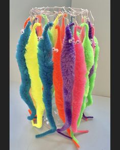 several colorful stuffed fish hanging from hooks