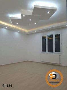 an empty room with white walls and wooden floors, lights on the ceiling are dimming