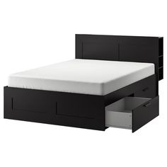 a bed with two drawers underneath it