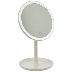 a white table top with a mirror on it