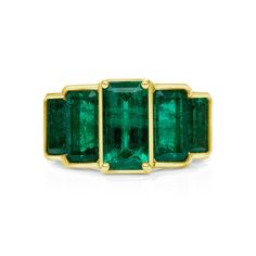 This modern and sleek emerald ring is truly a must-have to add a pop of color for both an everyday or evening look. It consists of 5 emerald cut Zambian emeralds and a bezel set in 18KT yellow gold. Zambian Emeralds are famous for the bluish undertone in color and has a higher clarity and hardness than other emeralds. 5 x 1.27CT Emerald Cut Zambian Emeralds 18KT Yellow Gold Luxury Bezel-set Open Emerald Ring, Formal Emerald Ring With Rectangular Stone And Bezel Setting, 14k Gold Emerald Cut Art Deco Ring, Classic Emerald Ring With Rectangular Bezel Setting, Luxury Octagon Emerald Ring With Bezel Setting, Bezel Set Baguette Cut Emerald Ring, Emerald Baguette Cut Ring With Bezel Setting, Baguette Cut Bezel Set Emerald Ring, Baguette Cut Emerald Ring With Bezel Setting