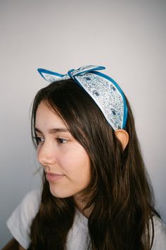 Add this feminine headband for the perfect finishing touch to your outfit! The scarf style bow knot detail is so fun and boho!  -Eye-catching satin fabrics -Bow knot detail -Comfortable, no-hurt headband -Soft, satin scarf-like fabric-covered for comfort wear -About 5.5 inch wide -One size fits all Blue Bohemian Bandana For Summer, Spring Adjustable Bandana Print Headscarf, Adjustable Bandana Print Headscarf For Spring, Summer Satin Headscarf, Summer Knotted Headscarf, Spring Satin Bow Hair Accessories, Spring Hair Accessories With Satin Bow, Blue Bohemian Headscarf For Summer, Bohemian Blue Headscarf For Summer