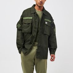 The Ranger series is part of the new AW24 Gahinga collection combining style & quality along with comfort. This piece is a re-worked outer shirt, and features a gorilla patch on the chest. It has multiple pockets, velcro patches and a waist adjustment cord.  Made from ripstop fabric, this is sourced from surplus military supply and re-worked in Greece.  Unisex item, in an oversized & baggy style. Suggested to size down.  For every item purchased, we make a donation directly to The Gorilla Organization on your behalf. Fabric-Ripstop Military Supply. Re-worked in Greece. Care instructions on label. Pre washed. Khaki Long Sleeve Tops With Cargo Pockets, Long Sleeve Streetwear Tops With Multiple Pockets, Long Sleeve Tops With Multiple Pockets For Streetwear, Cotton Long Sleeve Tops With Multiple Pockets, Long Sleeve Cotton Tops With Multiple Pockets, Utility Tops With Patch Pockets For Streetwear, Long Sleeve Tops With Patch Pockets For Streetwear, Khaki Military Top With Patch Pockets, Khaki Military Tops With Patch Pockets