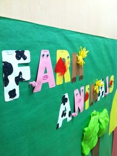 a green bulletin board with farm animals on it and the word farm written in large letters