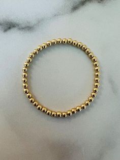 4 mm round gold-filled beads on elastic. Will not fade or tarnish.  Made to order by hand. Please reach out with any questions, including expediting orders. Please note that the sizes listed are the size of the actual bracelet, not of the wrist. Please see sizing instructions before ordering. Gold Filled, Jewelry Bracelets, Beaded Bracelets, Elastic, Bracelet, Beads, Gold, Art, Jewellery Bracelets