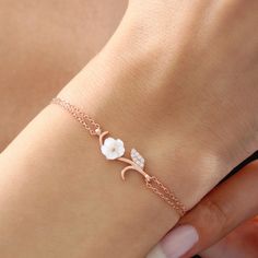 The magnolia-like flower on the bracelet is made of original mother-of-pearl stone. The mother-of-pearl stone represents power, grace and abundance. In addition, proximity to the mother-of-pearl stone has many benefits in energy. The two-stranded bracelet design that combines mother-of-pearl stone with the bracelet represents the journey of life and the elegance of women. It has a design that you will always carry with you in your daily life, on an important date, on the beach or at a great part Rose Gold Flower Shaped Bracelets For Wedding, Flower-shaped Bracelets For Bridesmaids, Dainty Rose Gold Flower-shaped Bracelets, Dainty Rose Gold Flower Bracelets, Delicate White Flower-shaped Bracelet, Rose Gold Bracelet With Flower Charm As Gift, Dainty Rose Gold Bracelet With Flower Charm, Rose Gold Flower Shaped Bracelets For Gifts, Rose Gold Flower-shaped Bracelets As Gifts