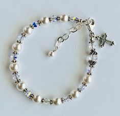 "Rosary bracelet-Granddaughter gift-Goddaughter bracelet-Goddaughter Gift-Goddaughter Present-Baby pearl bracelet-Cross bracelet-Pearl Rosary-Pearl Rosary Bracelet-Chaplet Bracelet-Flower girl bracelet-Christening bracelet-Communion bracelet This beautiful Rosary Bracelet features with Swarovski Crystal White Pearl round beads, Swarovski Crystal Bicone AB, Bali silver Daisy rondelle, and sterling silver clasp. This bracelet is approximately 6 1/2\" in length. All Parts are sterling silver. The b Adjustable Hypoallergenic Rosary Bracelet For Wedding, Elegant White Rosary Bracelet For Birthday, Classic Adjustable Jewelry For First Communion, Elegant Round Beads Bracelets For First Communion, Elegant Round Beads Bracelet For First Communion, Spiritual Round Beads Bracelets For Baptism, Elegant Personalized Bracelets For Confirmation, Elegant Adjustable Beaded Bracelets For Baptism, Adjustable White Bracelet For Confirmation