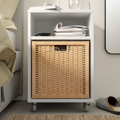 a wicker basket sits on top of a white cabinet