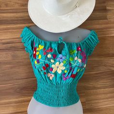 Cute Mexican Handmade Floral Embroidery Crop Top With Elastic Band All Around And Off The Shoulder Neckline, Simply Perfect For The Woman That Prefer A Modern Version Of The Traditional Clothing. One Size Fits S-M Follow Me On Instagram @Vanesaboutiqueny Blue Floral Embroidered Top For The Beach, Blue Floral Embroidered Top For Beach, Blue Embroidered Top With Floral Detail For Beach, Casual Embroidered Top With Tonal Embroidery For Summer, Casual Embroidered Top For Summer, Blue Floral Embroidered Top For Vacation, Embroidered Green Beach Top, Embroidered Green Top For The Beach, Casual Fitted Embroidered Top With Multicolor Embroidery