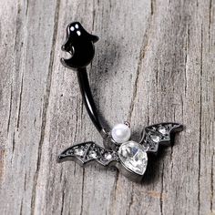 Clear Gem Black Ghost Vampire Bat Halloween Double Mount Belly Ring Start your Halloween shopping with a little treat for yourself with this 14 gauge navel jewelry with tons of holiday spirit. Made with a 3/8" black PVD over 316L surgical grade stainless steel curved barbell, this navel piercing features a black ghost top charm and a vampire bat bottom charm set with clear gems and a white orb for very spooky style.Specifications14 Gauge (1.6mm), 3/8" (10mm), Black PVD over 316L Surgical Grade S Silver Body Jewelry For Halloween, Halloween Silver Body Jewelry Gift, Gothic Piercings For Halloween Gift, Black Piercings For Halloween Gift, Black Ghost, Jewelry Promotion, Spooky Style, Bat Halloween, Navel Jewelry